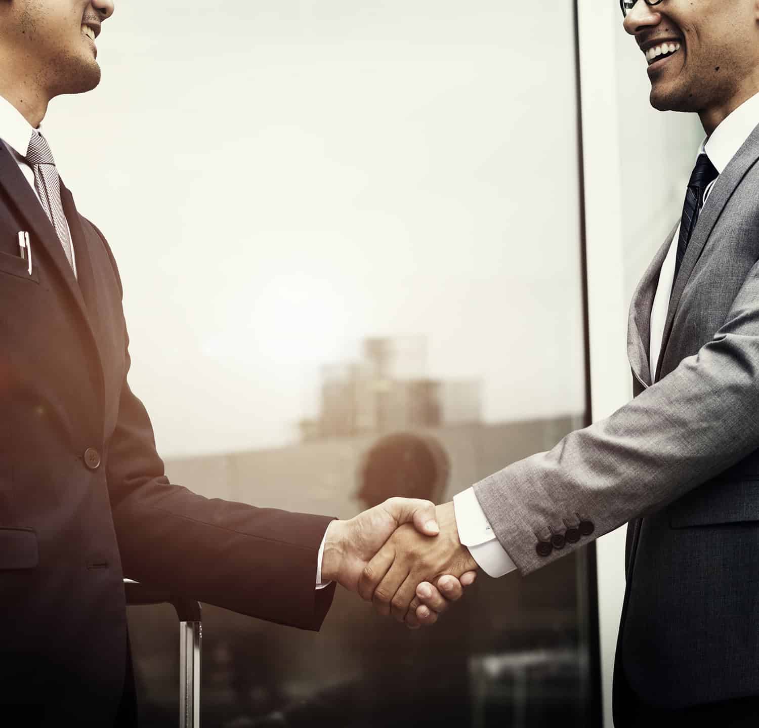 Corporate businessmen shaking hands